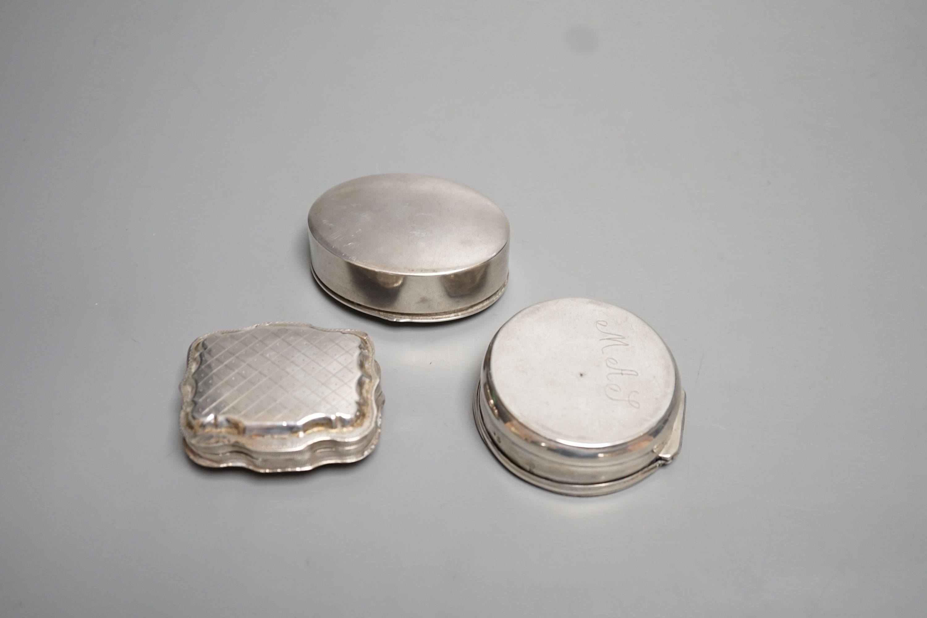 Three assorted continental white metal pill boxes including Dutch with filigree panel and German, largest 66mm.